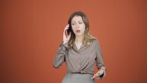 Angry-young-woman-talking-on-the-phone.